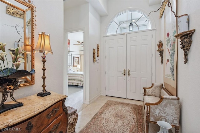 entrance foyer featuring light tile patterned floors and ceiling fan