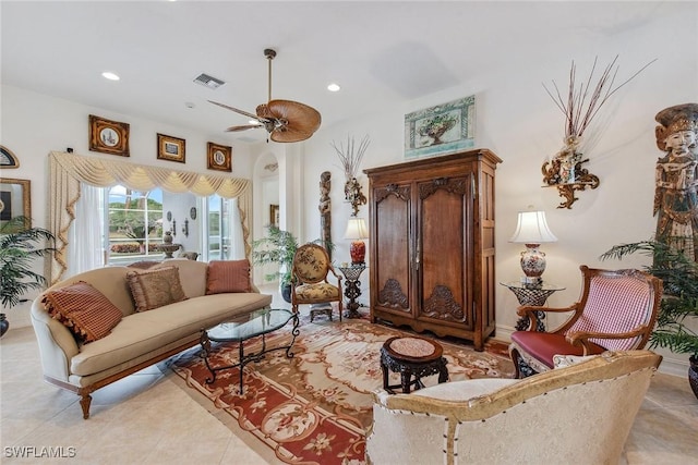 living area featuring ceiling fan and light tile patterned floors