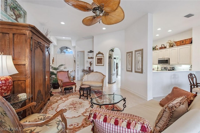 tiled living room with ceiling fan