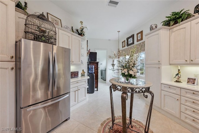 8469 Mallards Way, Naples, FL 34114 - kitchen with freestanding refrigerator, light countertops, light tile patterned floors, and hanging light fixtures