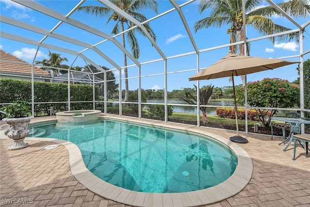 view of pool with a lanai, a patio area, an in ground hot tub, and a water view