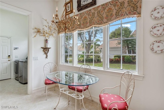 tiled dining room with washing machine and clothes dryer