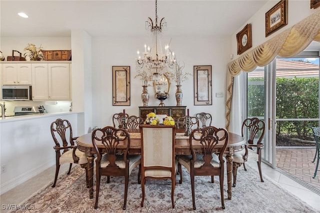 dining room featuring light tile patterned floors and an inviting chandelier