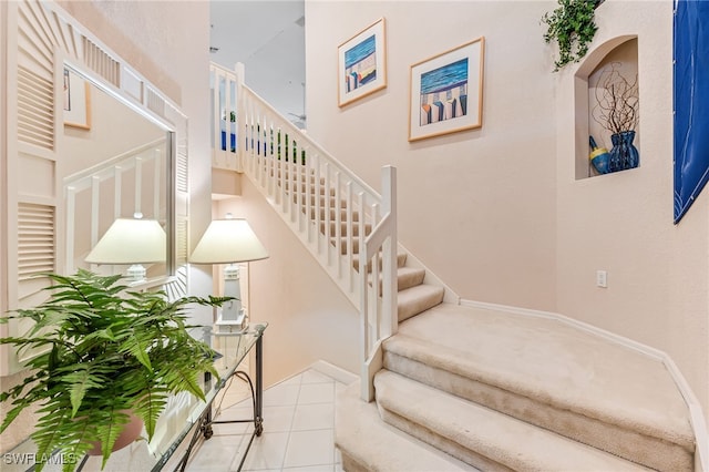 staircase featuring a high ceiling