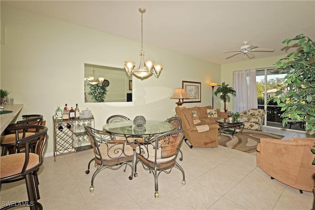 tiled dining space featuring ceiling fan with notable chandelier