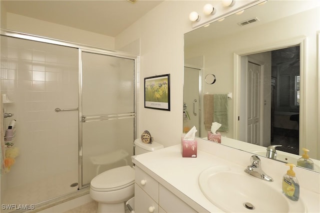 bathroom featuring vanity, toilet, and walk in shower