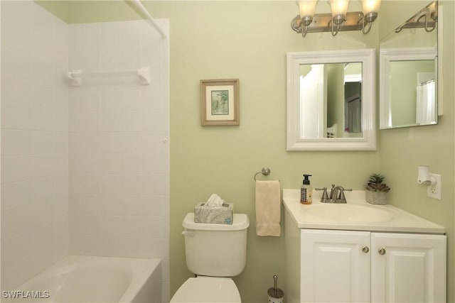 full bathroom featuring tiled shower / bath combo, vanity, and toilet