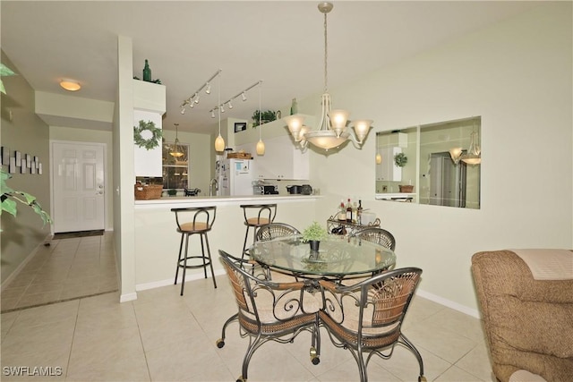 dining room featuring a notable chandelier and light tile patterned flooring