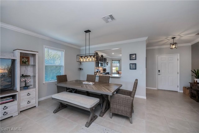 dining room with light tile patterned flooring and crown molding