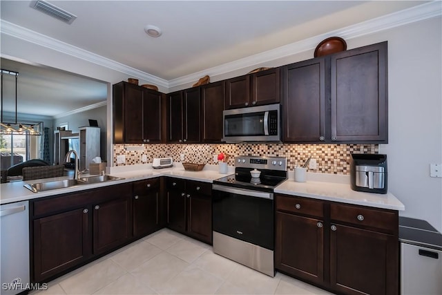 kitchen with sink, backsplash, dark brown cabinets, and stainless steel appliances