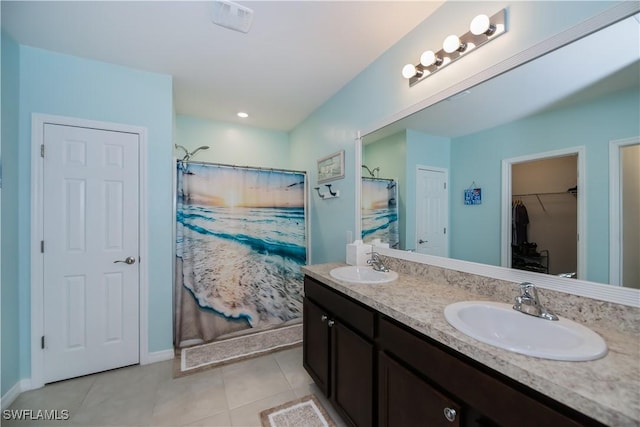 bathroom with a shower with shower curtain, vanity, and tile patterned flooring