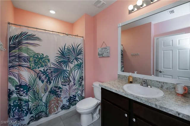 bathroom with tile patterned floors, vanity, and toilet