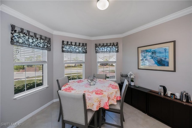 dining space featuring crown molding and light tile patterned flooring