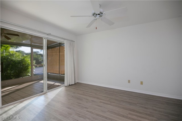 spare room with hardwood / wood-style floors and ceiling fan