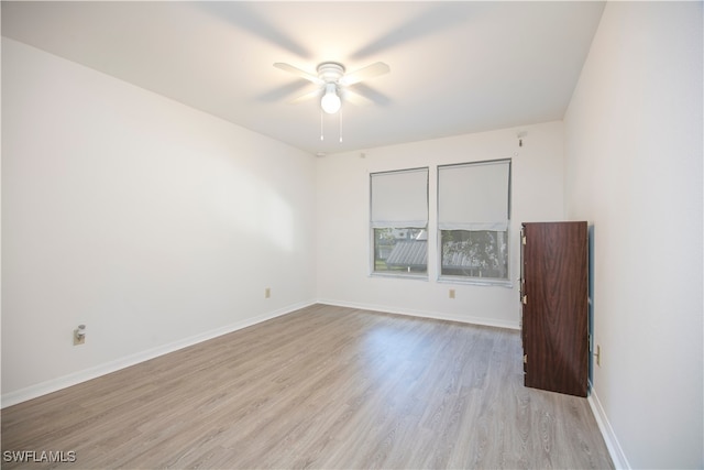 spare room with ceiling fan and light wood-type flooring