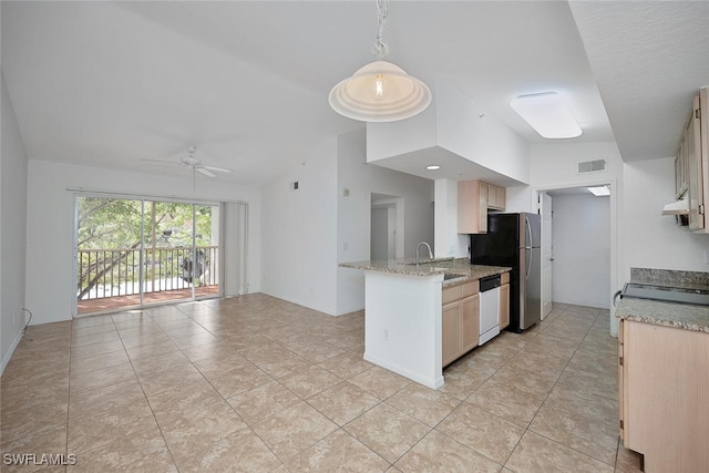 kitchen with light brown cabinetry, sink, hanging light fixtures, appliances with stainless steel finishes, and kitchen peninsula