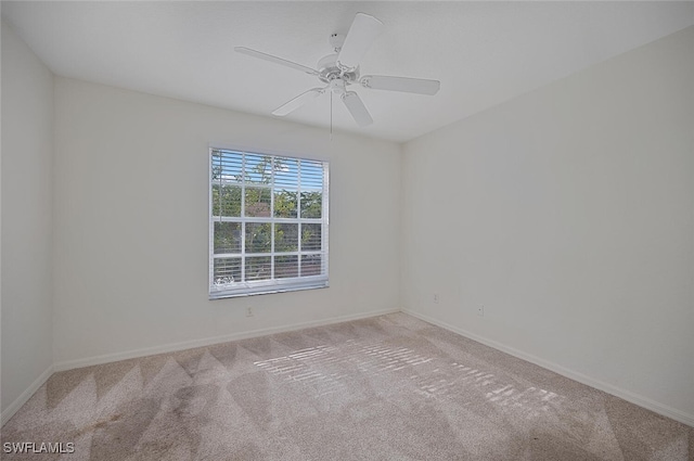 empty room with light colored carpet and ceiling fan