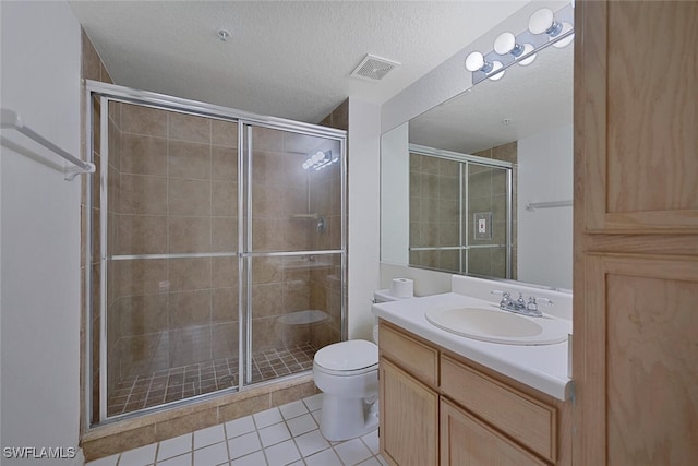 bathroom with toilet, an enclosed shower, a textured ceiling, vanity, and tile patterned flooring