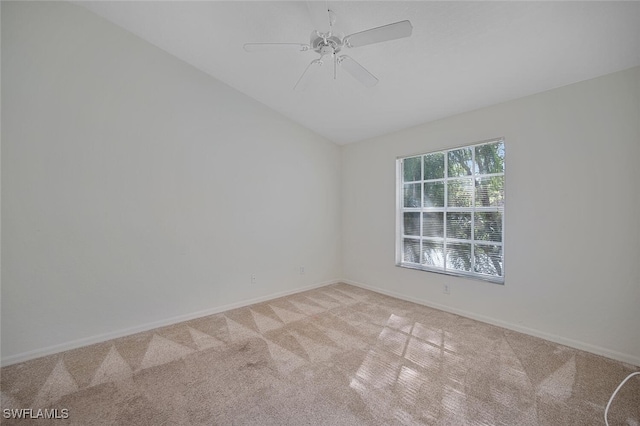 spare room with lofted ceiling, light colored carpet, and ceiling fan