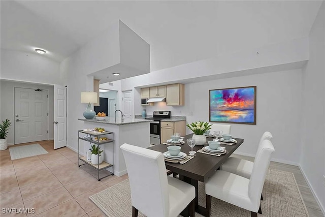 4650 Saint Croix Ln Unit 736, Naples, FL 34109 - dining room with baseboards, light tile patterned flooring, and high vaulted ceiling
