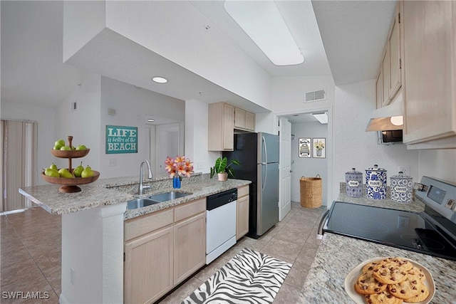 4650 Saint Croix Ln Unit 736, Naples, FL 34109 - kitchen with stainless steel appliances, a sink, a peninsula, light tile patterned floors, and under cabinet range hood