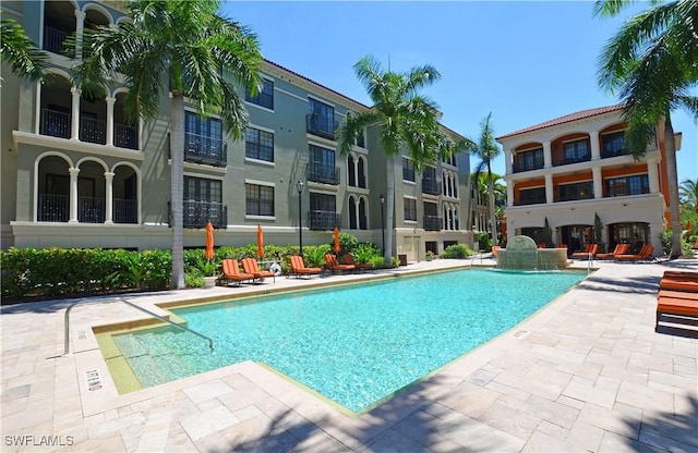 view of swimming pool featuring a patio and pool water feature