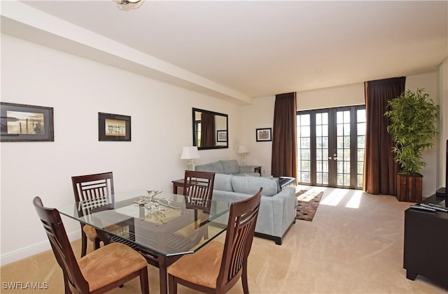 carpeted dining area featuring french doors