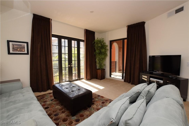 carpeted living room with french doors