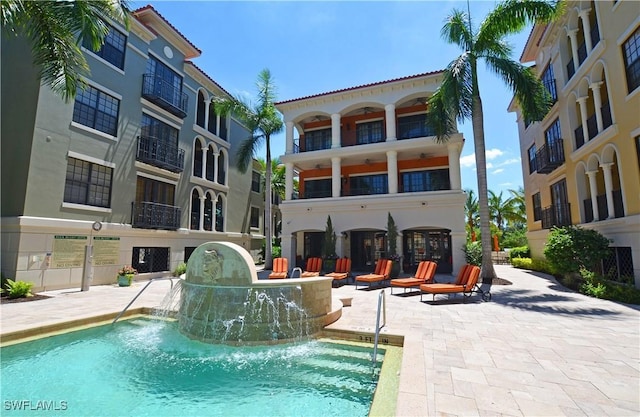 view of pool with pool water feature and a patio area