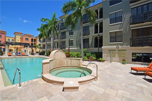 view of swimming pool with a pergola, a community hot tub, and a patio area