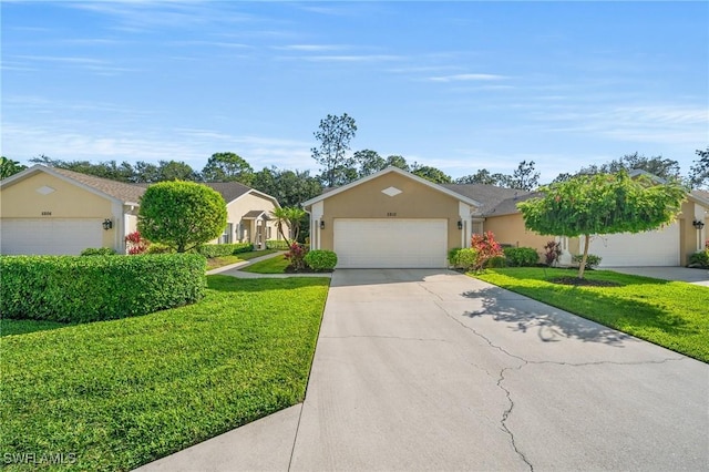 ranch-style house with a garage, a front yard, concrete driveway, and stucco siding