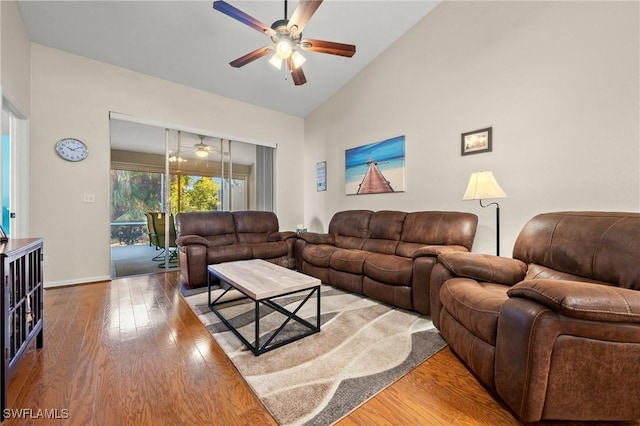 living area with ceiling fan, high vaulted ceiling, hardwood / wood-style floors, and baseboards