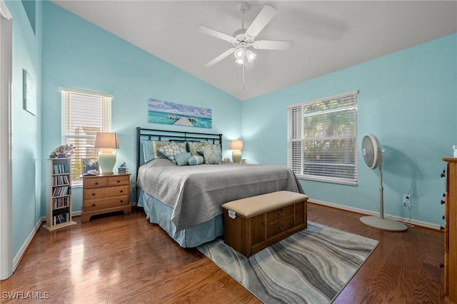 bedroom featuring lofted ceiling, wood finished floors, and baseboards