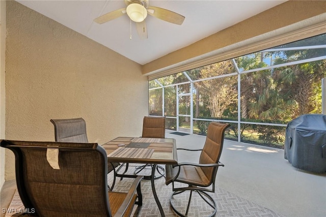 sunroom with lofted ceiling and a ceiling fan