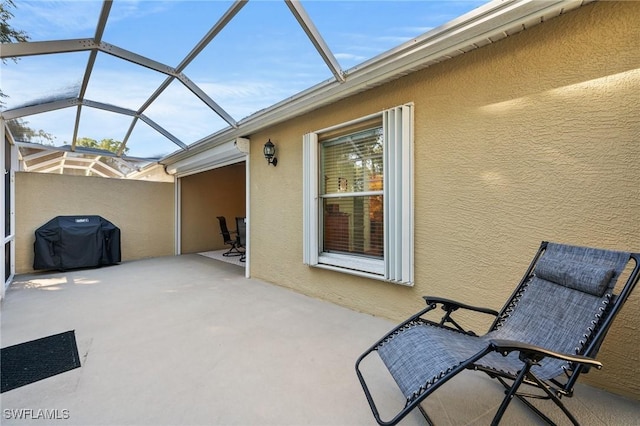 view of patio / terrace featuring glass enclosure and area for grilling