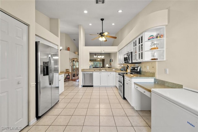 kitchen featuring light tile patterned flooring, ceiling fan with notable chandelier, a sink, white cabinets, and appliances with stainless steel finishes