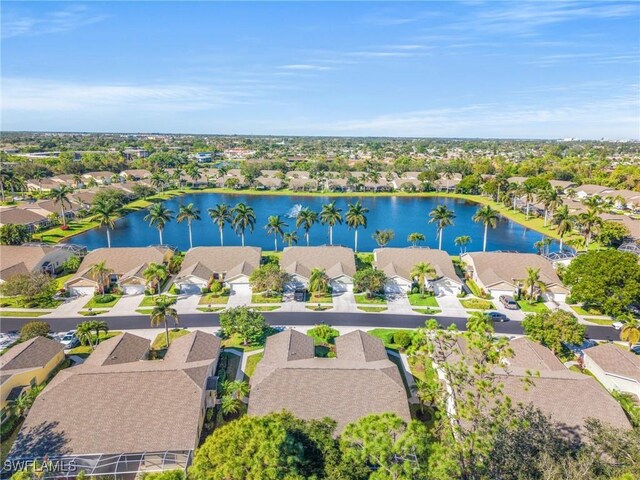 birds eye view of property with a water view and a residential view