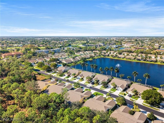 drone / aerial view featuring a residential view and a water view