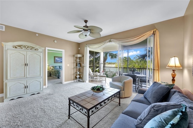 carpeted living room featuring ceiling fan