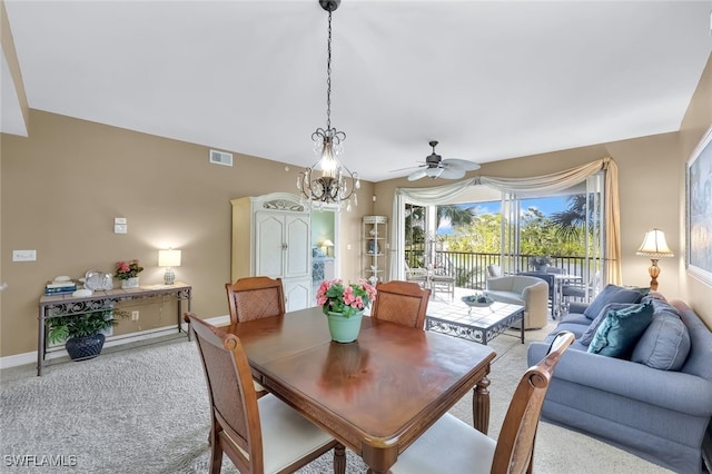 dining space with ceiling fan and carpet flooring