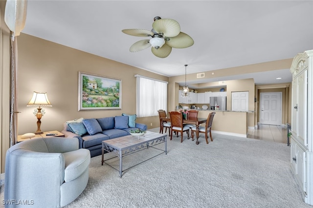 living room featuring light colored carpet and ceiling fan