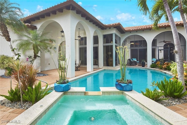 back of house with ceiling fan and a patio area