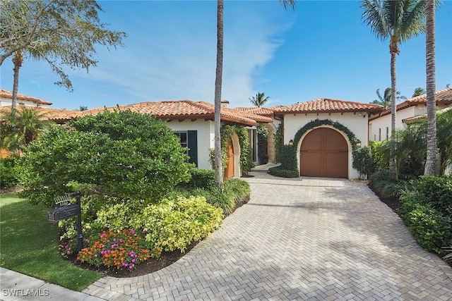 mediterranean / spanish-style house with a garage