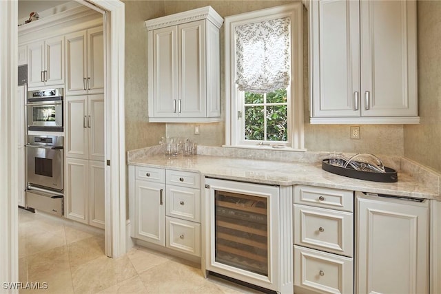 kitchen with double oven, light stone countertops, beverage cooler, and light tile patterned flooring