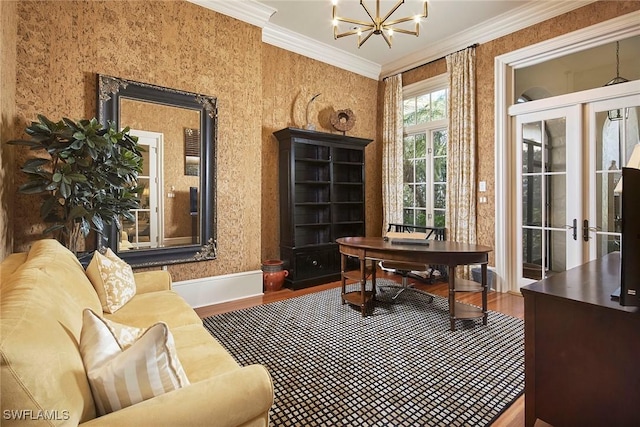 home office featuring an inviting chandelier, hardwood / wood-style floors, crown molding, and french doors