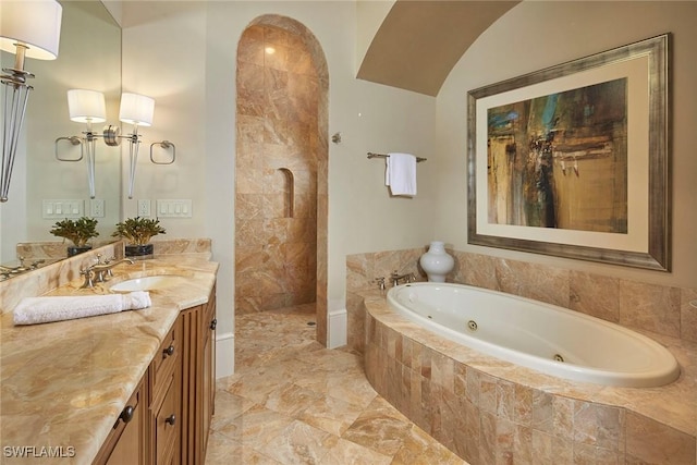 bathroom with vanity and separate shower and tub