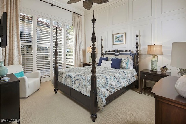 bedroom with ornamental molding, carpet, and ceiling fan