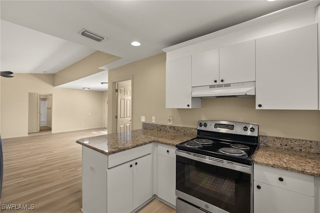 kitchen with electric stove, kitchen peninsula, white cabinets, dark stone counters, and light wood-type flooring