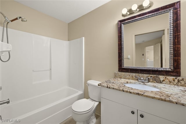 full bathroom featuring vanity, bathtub / shower combination, and toilet