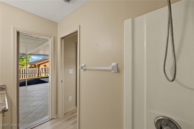 bathroom with hardwood / wood-style floors and walk in shower